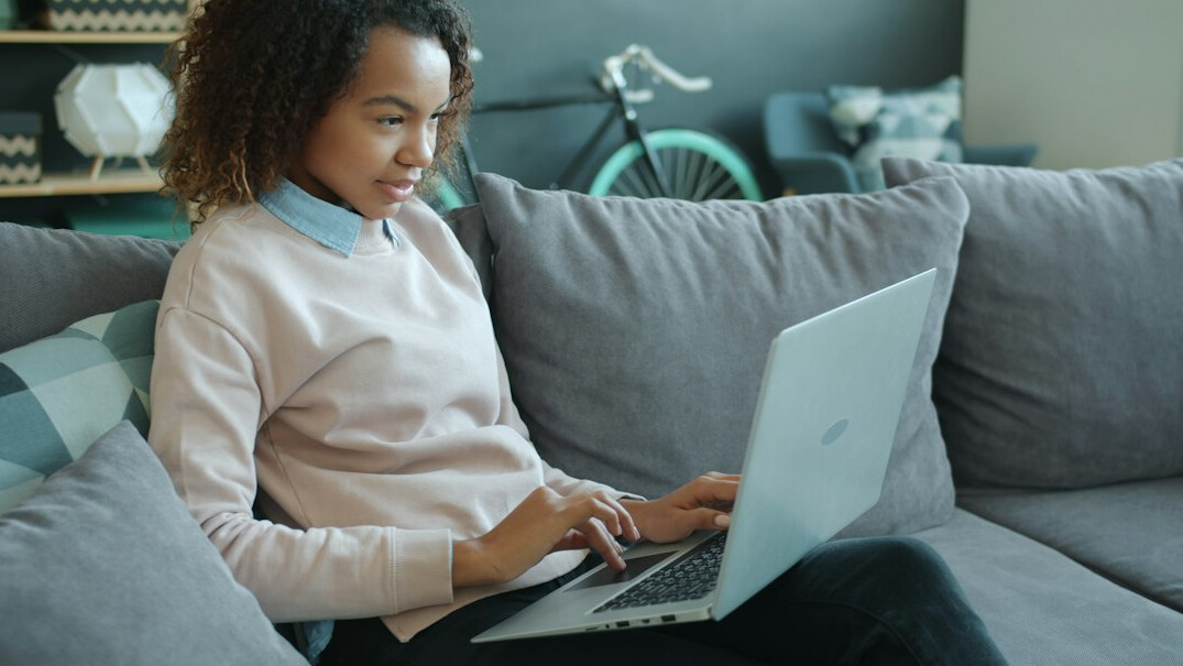 woman coding at home desk